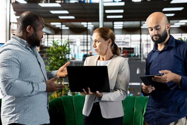 A group of diverse professionals collaborating around a table, working on laptops and tablets, and analyzing digital marketing data and charts. The setting is a modern, collaborative office space.