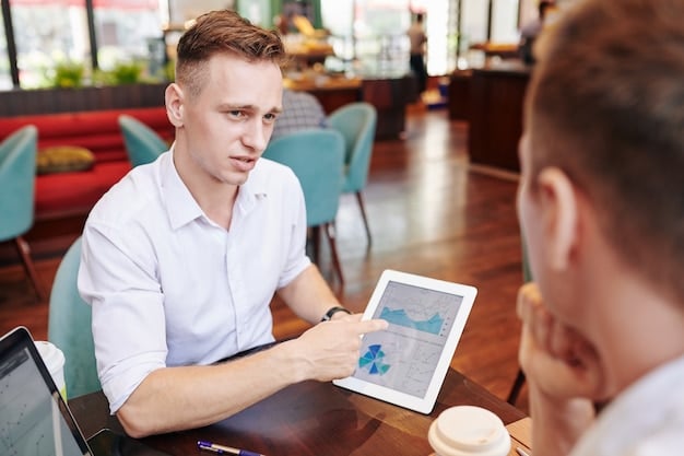 A salesperson presenting data insights from a tablet to a client in a meeting, illustrating how technology facilitates better communication and decision-making.