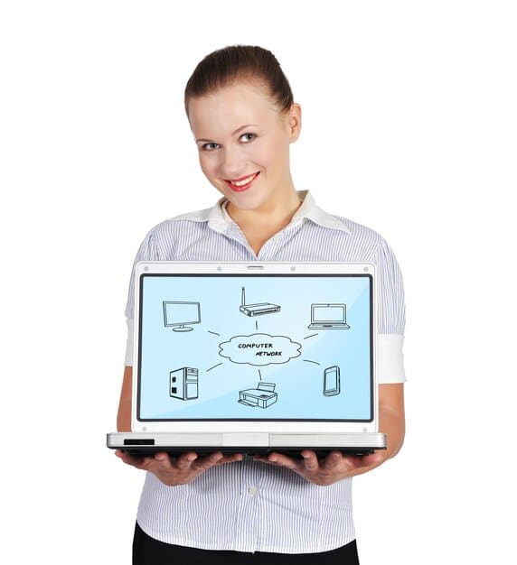 A sales representative using a CRM system on their laptop, showcasing territory management features such as customer tracking, sales performance analysis, and lead assignment. The visual emphasizes the role of technology in optimizing sales processes.
