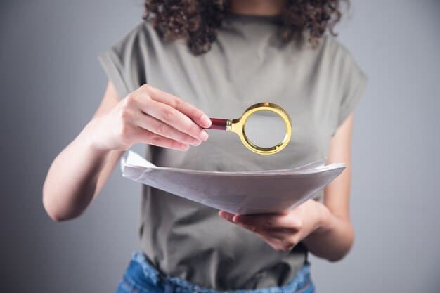 A close-up image of a hand holding a magnifying glass over a document titled 